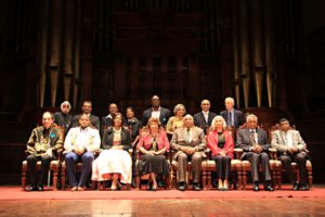 Behind the recipients are Mr Kay Munsamy( a Stalwart of the struggle), Mr Vasu Gounden(Trustee GDT), Mr Swaminathan Gounden(Stalwart of the struggle), Dr Albertinah Luthuli(Stalwart of the struggle,daughter of Chief Albert Luthuli the first nonwhite Nobel Peace Prize Recipient), Cllr Sipho Kaunda (representing the Mayor of eThekwini) Ela Gandhi (Trustee GDT), Judge Chiman Patel(Trustee GDT) Paddy Kearney (Trustee GDT)
